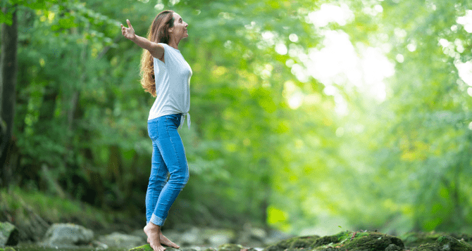 Woman taking a deep breath in nature