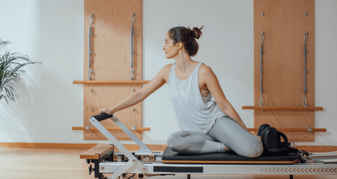 Woman training on a reformer