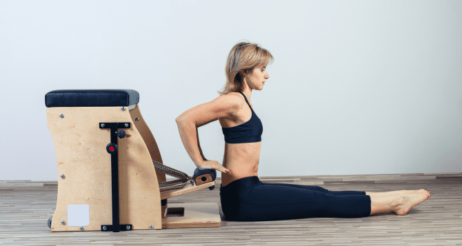 Woman doing pilates exercises on a chair