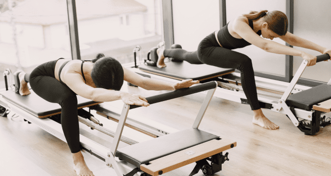 two women doing reformer