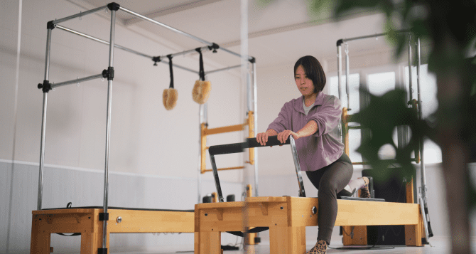 Japanese woman doing a reformer