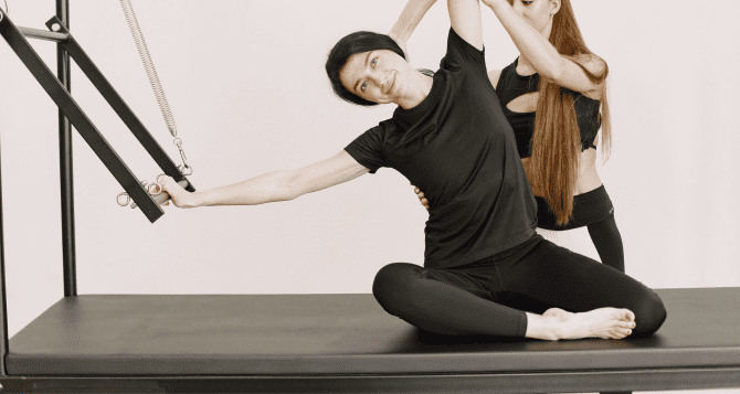 A woman doing Pilates while bending to the side