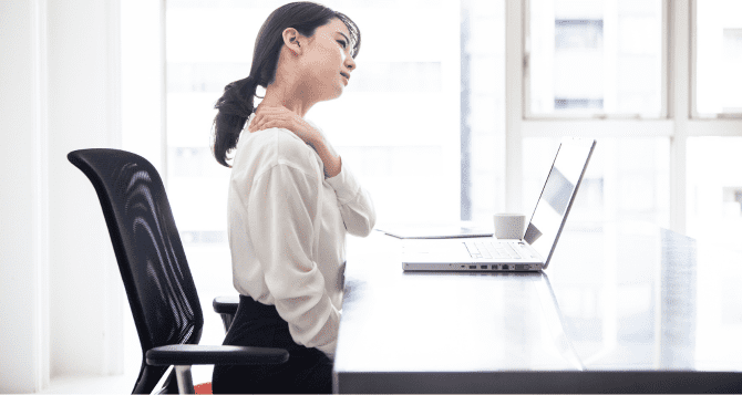 woman touching her shoulder