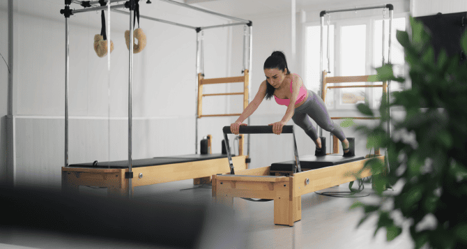 Woman doing reformer in plank position